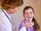 Now say aaah. Shot of a pediatrician examining a little girl in her office.