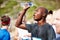 Now thats refreshing. a young male runner pouring water over himself after a road race.