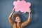 Now theres a winning idea. Studio shot of a young woman holding a thought bubble against a grey background.