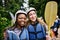 Now that was a workout. Portrait of two cheerful young women wearing protective gear while holding a rowing paddle