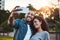 Now well never forget this day. a young couple taking selfies together outdoors.