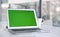 Now that weve got your attention...a laptop with a green screen on a desk in a modern office.