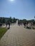 Noyabrsk, Russia - May 30, 2020: Children run and ride near the city fountain. Vertical