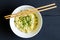 Nstant noodles in bowl closeup top view with chop sticks on rust