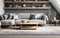 nterior of modern living room with gray walls, wooden floor, brown sofa and bookshelves.