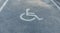 nternational markings for a handicapped parking. Disabled symbol sign on asphalt in parking space. I