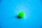 Nucleus, Coronavirus molecule. Flu virus of green and red color on a blue background. Flu vaccine, coronavirus. Copy Space. Covid-
