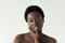 Nude african american woman touching face