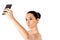 Nude beautiful woman taking selfie on white background.