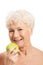 Nude old woman holding and apple.