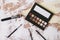 Nude palette of shadows and brush. Fashion, beauty concept. Professional makeup decorative cosmetics. Flat lay, top view