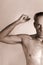 Nude portrait of a man with autism who demonstrates his physical muscle strength