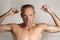 Nude portrait of a man with autism who demonstrates his physical muscle strength