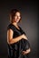 Nude pregnant woman in black dress