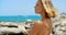 Nude Woman Enjoying View of Ocean on Rocky Beach