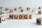 Nudge - word from wooden blocks with letters