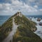 Nugget Point lighthouse trail and rocks in the ocean in Otago