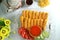 Nugget sticks fish fried crunchy line up with ketchup cucumber tomatoes on transparent tray set with teapot cup flower and breaded