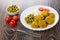 Nuggets with rice, tomatoes cherry, bowl with green peas, fork