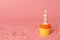 Number 1 candle in a cupcake against a pastel pink background. First bithday cake. Copy space