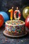 Number 10 candle on celebratory cake with balloons, party decor on blurred background