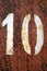 Number 10 in stencil on grungy orange color metal wall