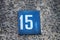 number 15 on a stone  wall