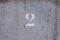 number 2 painted on a worn concrete wall