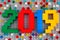 Number 2018 made from Lego bricks on gray baseplate with scatter