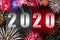 Number 2020 on the counter with fireworks. Happy new year concept