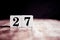 Number 27 isolated on dark background- 3D number twenty seven isolated on vintage wooden table