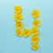 Number 4 on a blue background from yellow bright spring flowers. Children`s age, baby month, symbol of flowers