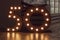 Number 50 carved from wood with bright bulbs around the perimeter. The concept of discounts and sales in stores, an important date