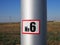 Number 6 on a silver post in the nature