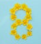 Number 8 on a blue background from yellow bright spring flowers. Children`s age, baby month, symbol of flowers
