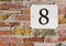 Number 8 Street Number on a Brick Wall