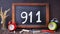 The number 911 written on chalkboard to indicate emergency