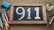 The number 911 written on chalkboard to indicate emergency