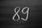 Number eighty nine enumeration written with a chalk on the blackboard