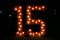 Number fifteen with lights on; fifteen illuminated; colorful number