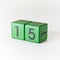 Number fifteen written on a wooden green cube on white background