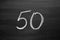 Number fifty enumeration written with a chalk on the blackboard