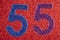 Number fifty-five blue purple over a red background. Anniversary