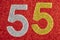 Number fifty-five silver gold over a red background. Anniversary