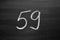 Number fifty nine enumeration written with a chalk on the blackboard