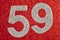 Number fifty-nine silver color over a red background. Anniversary.