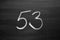 Number fifty three enumeration written with a chalk on the blackboard