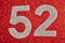 Number fifty-two silver over a red background. Anniversary.