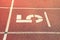 Number five. Big white track number on red rubber racetrack. Gentle textured running racetracks in athletic stadium.