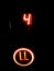 Number four and a call symbol in red neon of an elevator